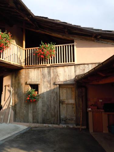 a building with two flower baskets on the side of it at B&B Il Mulino in Sanfront