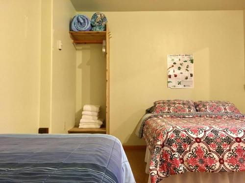 a bedroom with a bed and a shelf with towels at Volcano Inn Bed n Breakfast in Volcano