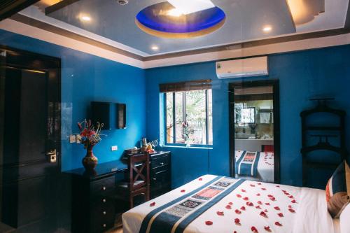 a blue bedroom with a bed and a mirror at Sapa Nature View Hotel in Sa Pa
