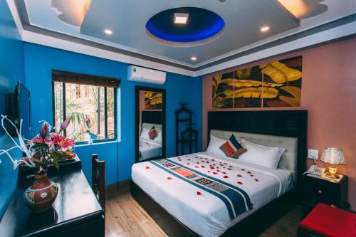 a bedroom with a large bed with blue walls at Sapa Nature View Hotel in Sa Pa