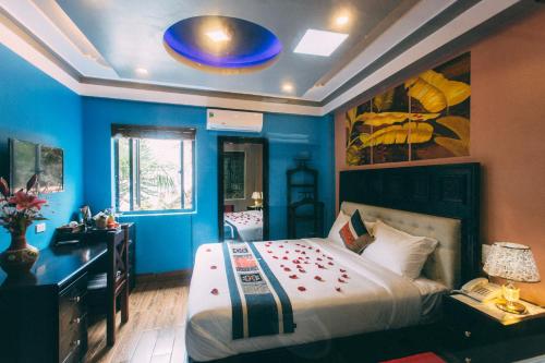 a bedroom with a large bed with a blue wall at Sapa Nature View Hotel in Sa Pa