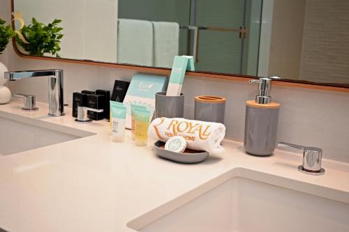 a bathroom counter with a sink with toiletries on it at Sandy 1BR Soul Beach Mamsha Al Saadiyat Island in Abu Dhabi