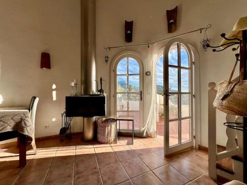 a living room with an open door and a television at apartment with magnificient Es Vedra view in Cala Vadella