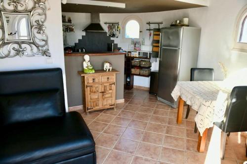 a kitchen with a table and a refrigerator at apartment with magnificient Es Vedra view in Cala Vadella