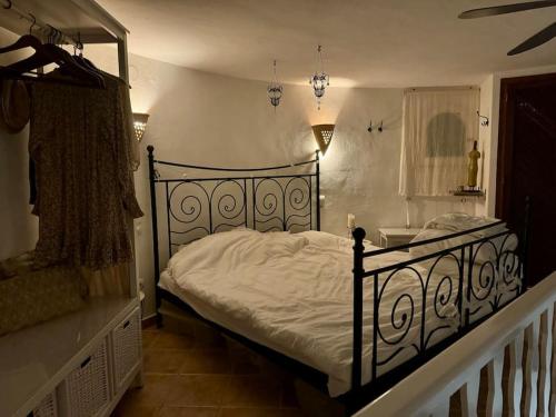 a bedroom with a bed with white sheets and a window at apartment with magnificient Es Vedra view in Cala Vadella