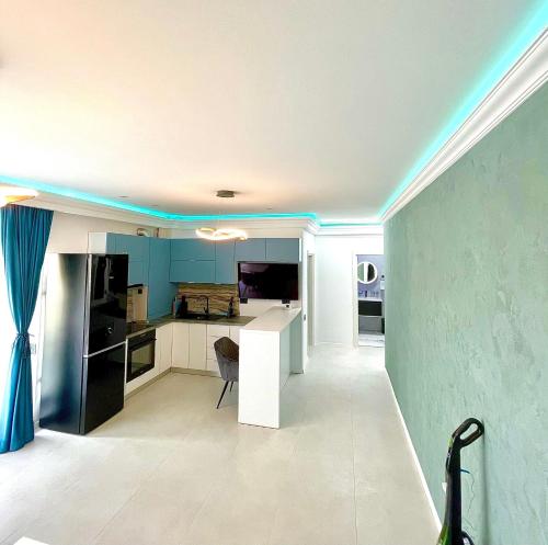 a kitchen with a white counter and blue walls at Summerland Seaview Apartments in Mamaia