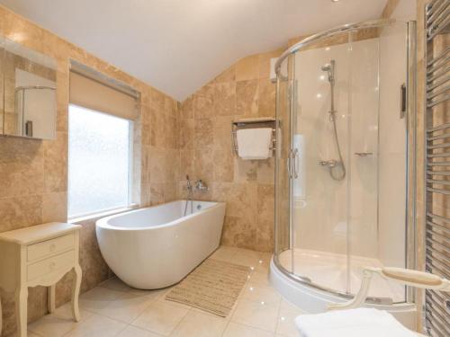 a large bathroom with a tub and a shower at 3 Bed in Keswick SZ030 in Keswick