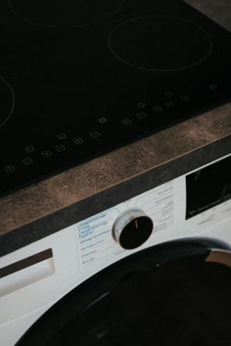 a close up of a washing machine with a dial at Résidence du Parc appartement calme in Châtel-Guyon