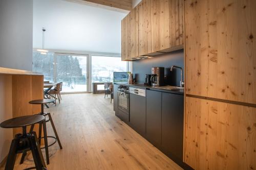 a kitchen with wooden walls and wooden floors at Chalets Coburg in Schladming