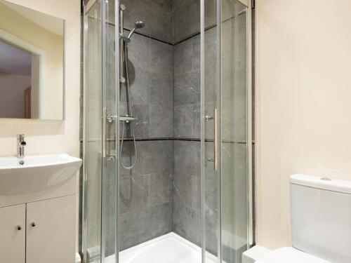 a shower with a glass door in a bathroom at 2 Bed in Bampton SZ271 in Bampton