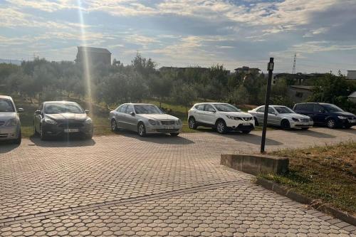 a group of cars parked in a parking lot at Vila Lufi in Kamëz