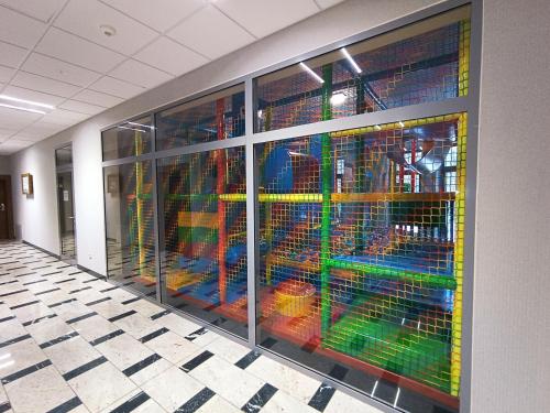 a building with a colorful glass wall in a hallway at Apartamenty Cypel Helski in Hel