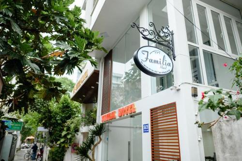 a sign for a restaurant on the side of a building at Familia Hotel in Hue