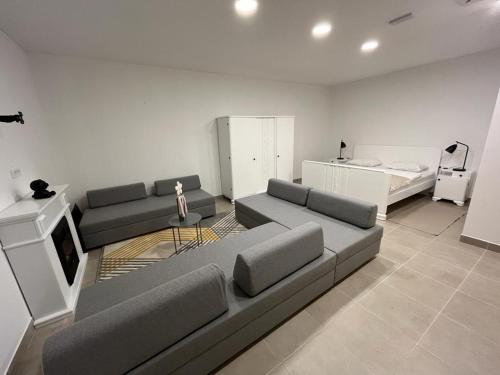 a living room with a couch and a bed at Antemurale - Luxury rooms,Plitvice Lakes in Rastovača