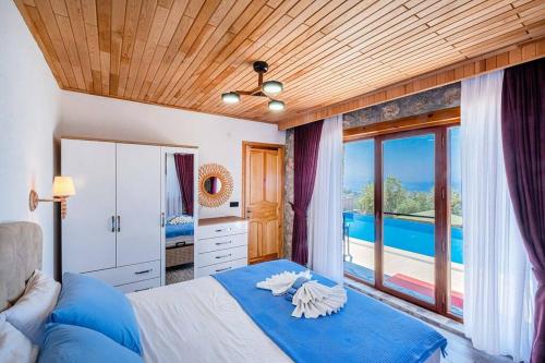 a bedroom with a bed with a view of the ocean at Villa Ahenk / Faralya in Fethiye