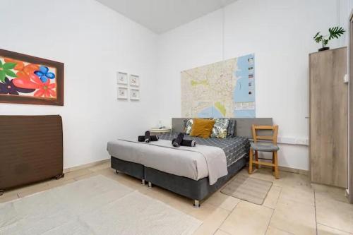 a bedroom with a bed and a desk and a chair at Cozy and Traditional EC Studios in Larnaka