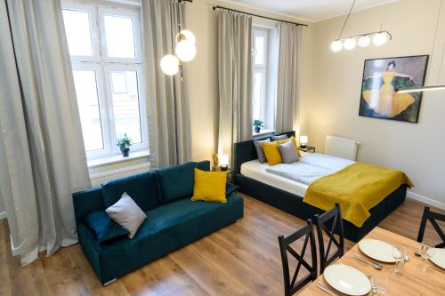 a living room with a bed and a couch at Chwaliszewo Deluxe Studio Old Town in Poznań