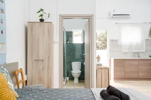 a bedroom with a bathroom with a toilet and a sink at Cozy and Traditional EC Studios in Larnaka