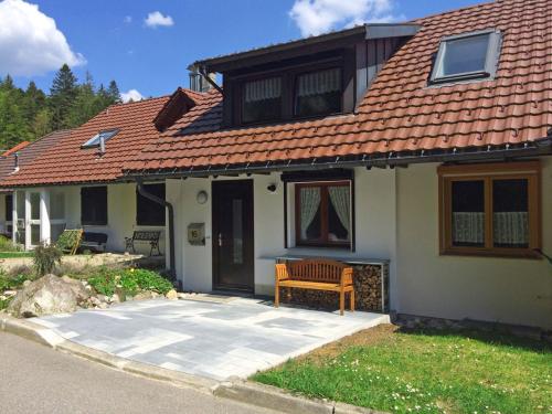 a house with a bench in front of it at Ferienhaus Fichte in Todtmoos