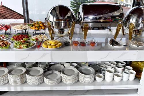 a shelf filled with plates and bowls of food at Sapa Nature View Hotel in Sa Pa