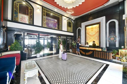 a bride and groom standing in the lobby of a hotel at Sapa Nature View Hotel in Sa Pa