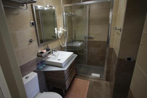a bathroom with a shower and a sink and a toilet at Apartment Superior in Fjesa
