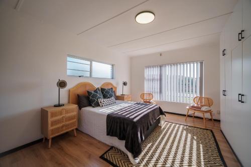 a bedroom with a bed and a window at Leadwood House in Jeffreys Bay