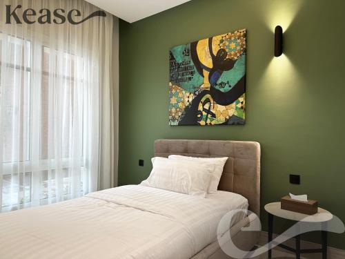 a bedroom with a bed and a painting on the wall at Kease King Salman K-7 Lusso Najd AX14 in Riyadh