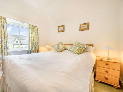 a bedroom with a white bed and a window at 2 Bed in Borrowdale SZ302 in Rosthwaite