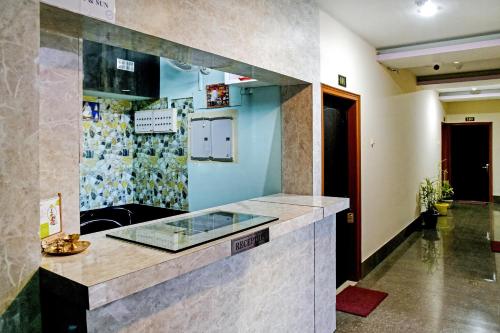 a kitchen with a counter with a glass counter top at OYO Flagship Hotel Rainbow in Tezpur