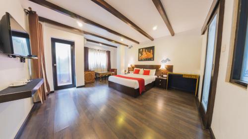 a hotel room with a bed and a television at Dalai-La Boutique Hotel in Kathmandu