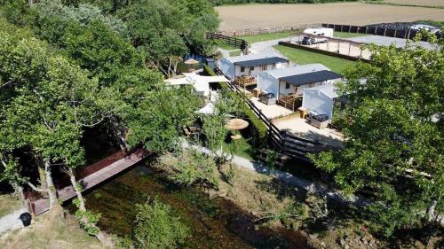 an overhead view of a house with trees and water at Camping Costa da Morte in Zas