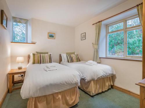 two twin beds in a room with a window at 3 Bed in Water Yeat SZ079 in High Nibthwaite