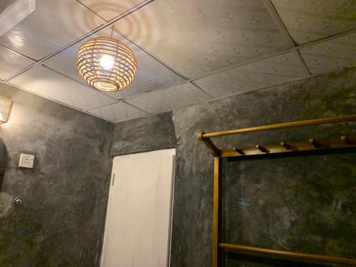 a room with a ceiling with a light and a door at Unrushed Midigama in Midigama