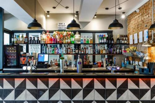 a bar with a lot of liquor bottles at OYO Ruby Pub & Hotel in Brighton & Hove