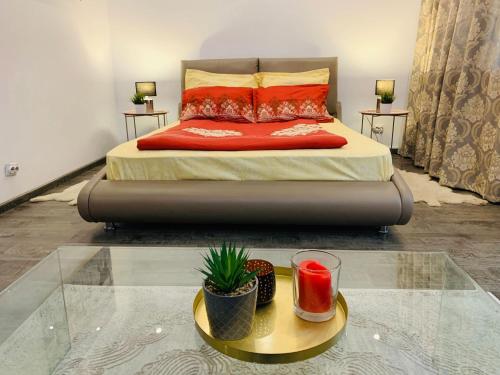 a bedroom with a bed and a glass table at SeasonsStudioBV in Braşov