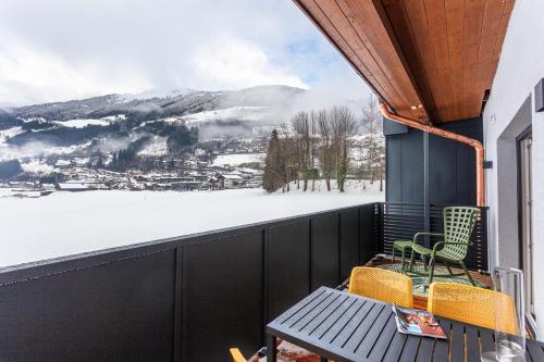 a balcony with a view of a snowy mountain at lechner living apartments in Wald im Pinzgau