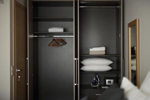 a walk in closet with towels and a mirror at Fivos Luxury Suite in Athens
