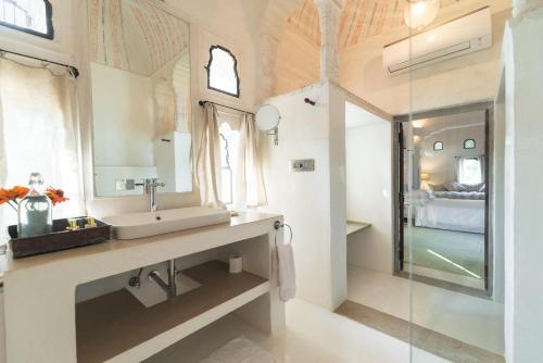 a bathroom with a sink and a mirror at DEEPPURA GARH in Sīkar