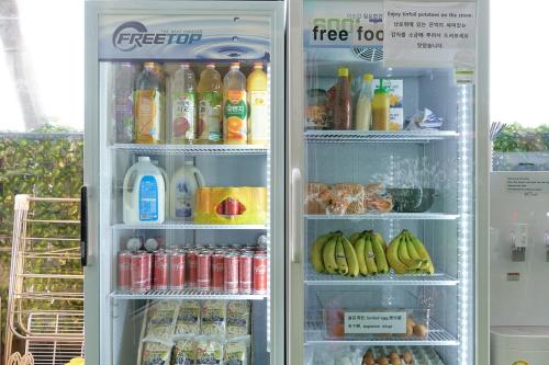 an open refrigerator full of drinks and drinks at Snowflower Guesthouse in Seoul