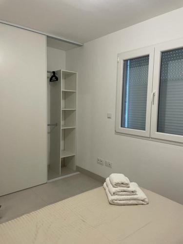 a white bathroom with a towel laying on the floor at Villa Lancrans in Lancrans