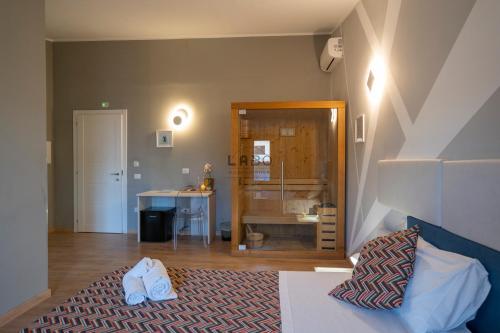 1 dormitorio con cama, espejo y escritorio en Agàpe Rooms in Tropea en Tropea
