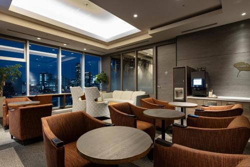 a restaurant with tables and chairs and a large window at Tokyu Stay Aoyama Premier in Tokyo