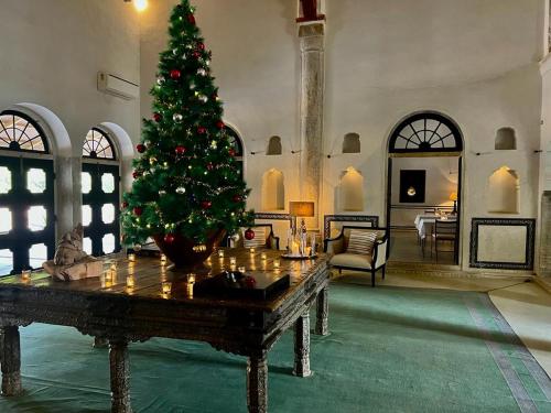 a christmas tree in a living room with a table at DEEPPURA GARH in Sīkar
