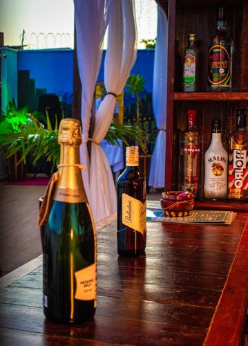 two bottles of wine sitting on a wooden table at Residence Pipa Beach in Pipa