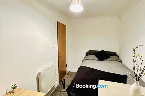 a small bedroom with a bed and a table at The Purple 5 Bedroom House By AltoLuxoExperience Short Lets & Serviced Accommodation With Free Parking in Bristol