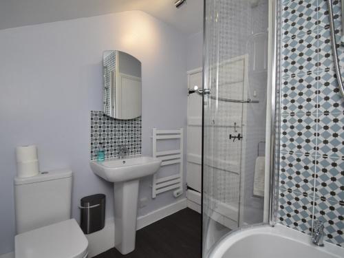 a white bathroom with a sink and a shower at 2 Bed in Glenridding SZ178 in Glenridding