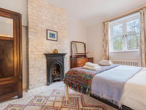 a bedroom with a bed and a fireplace at 3 Bed in Backbarrow SZ549 in Backbarrow