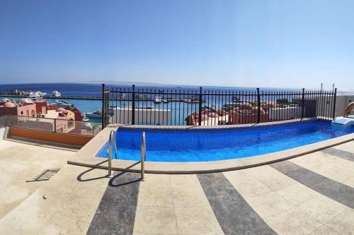 a blue swimming pool on top of a building at Condo with Breathtaking 's view with 2 bedrooms in Hurghada