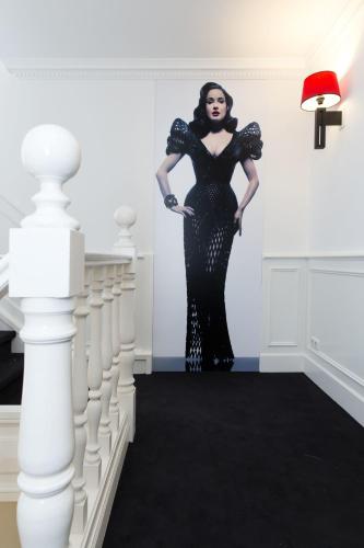 a woman in a black dress standing in a room at Le Theatre in Maastricht